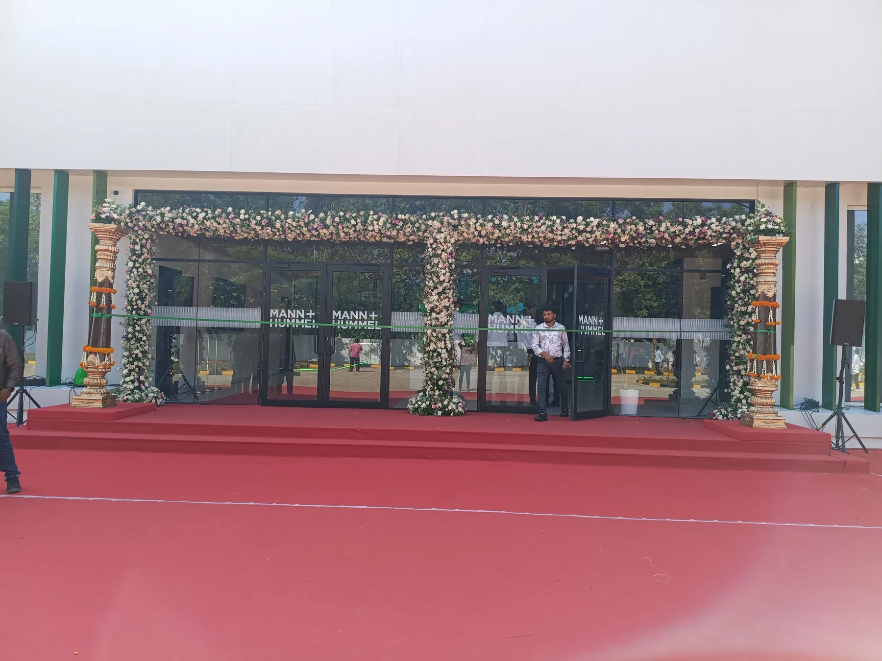 Flower-framed entrance and red carpet