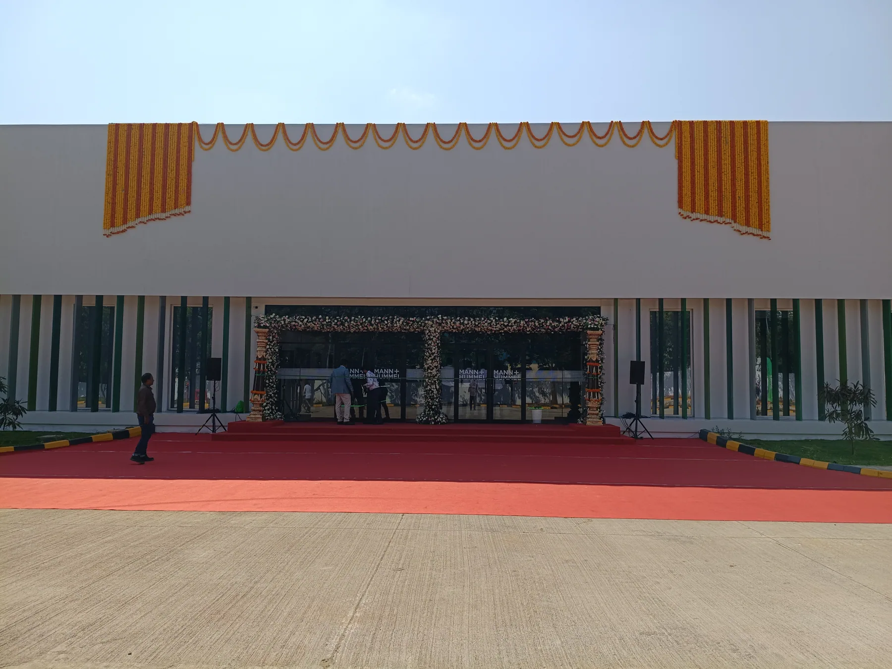 Wide view of the building entrance and arrival carpet