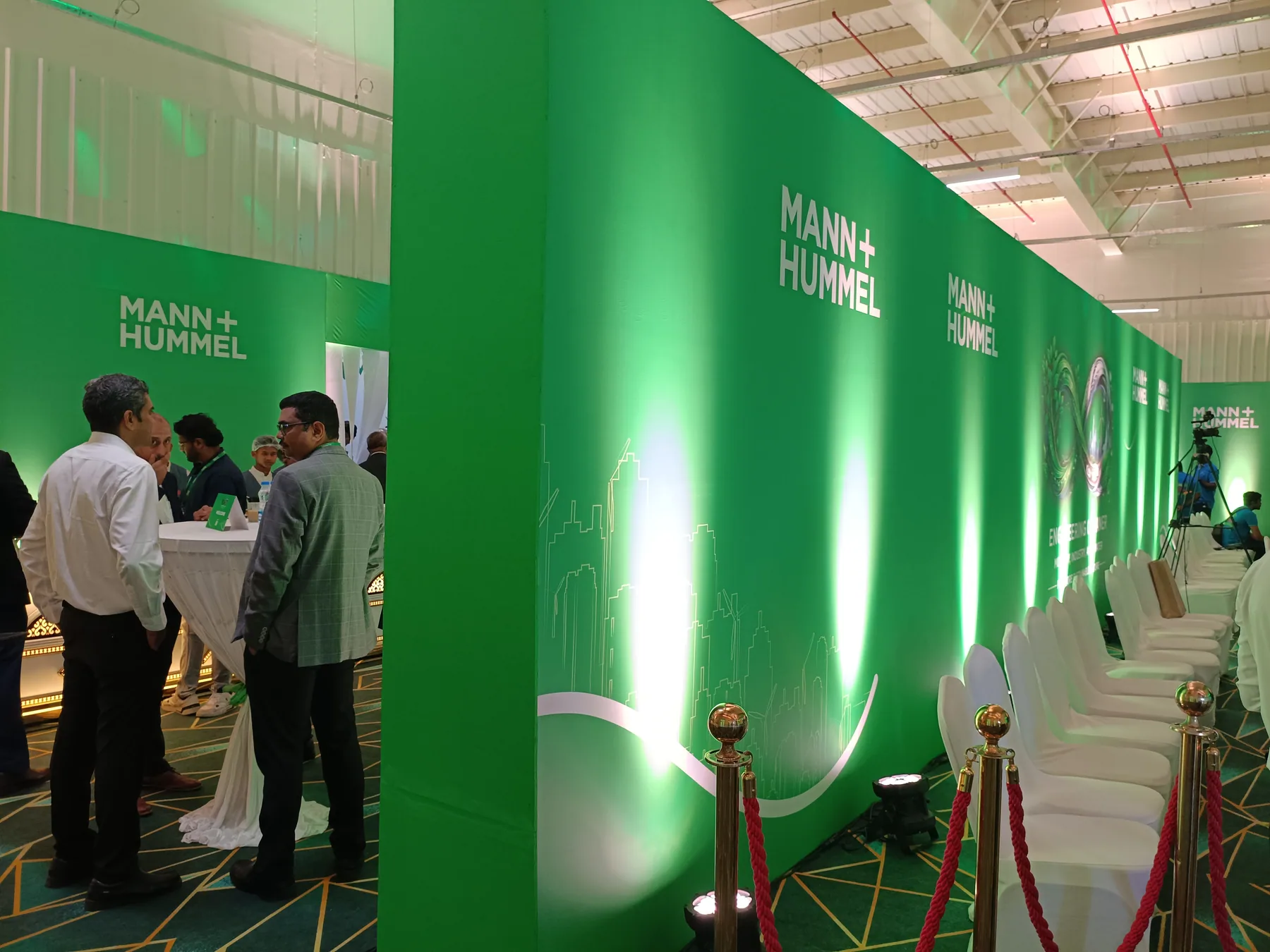 Green illuminated wall panels beside visitor seating