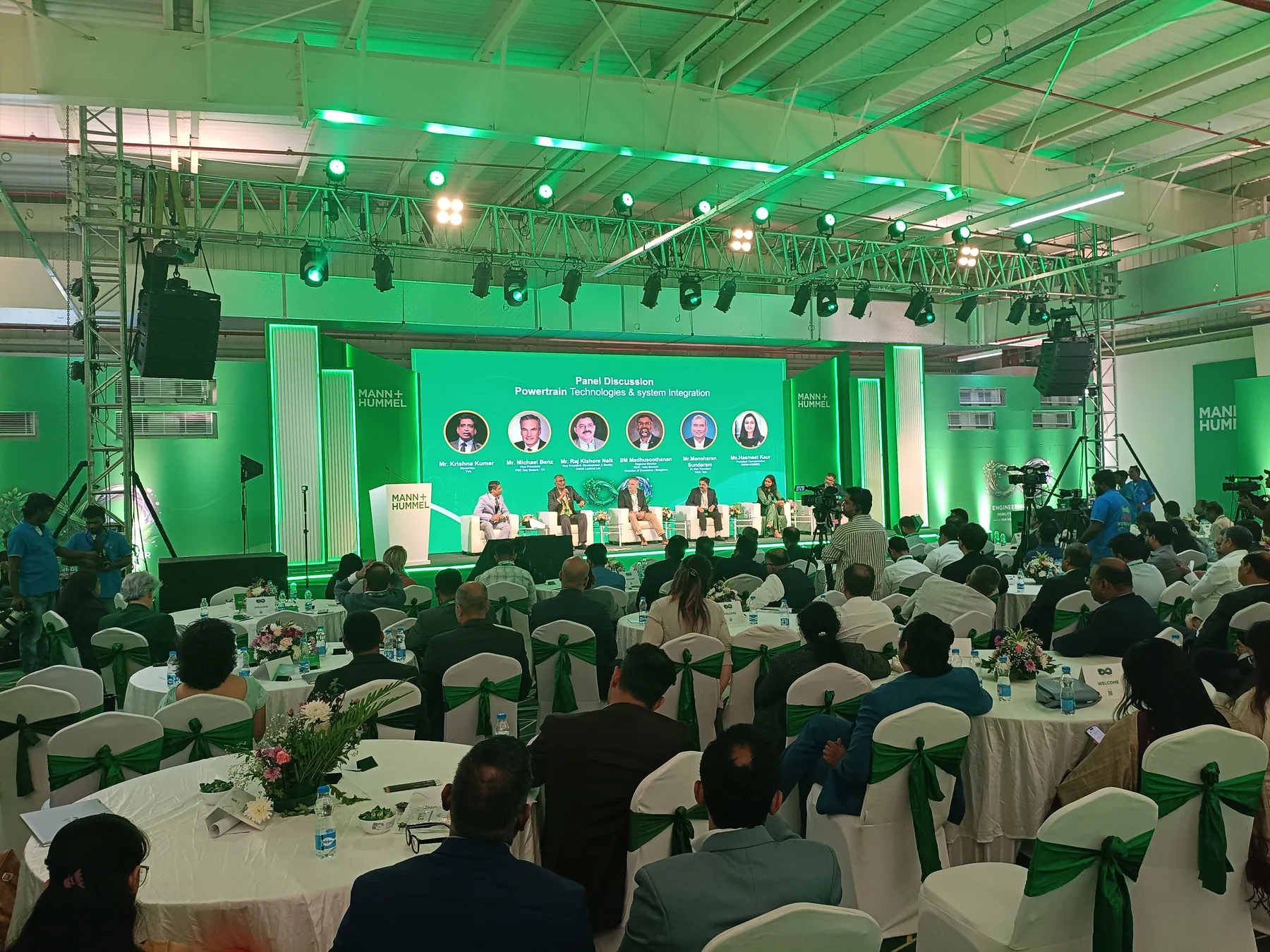 Panel discussion on the stage, viewed from the audience