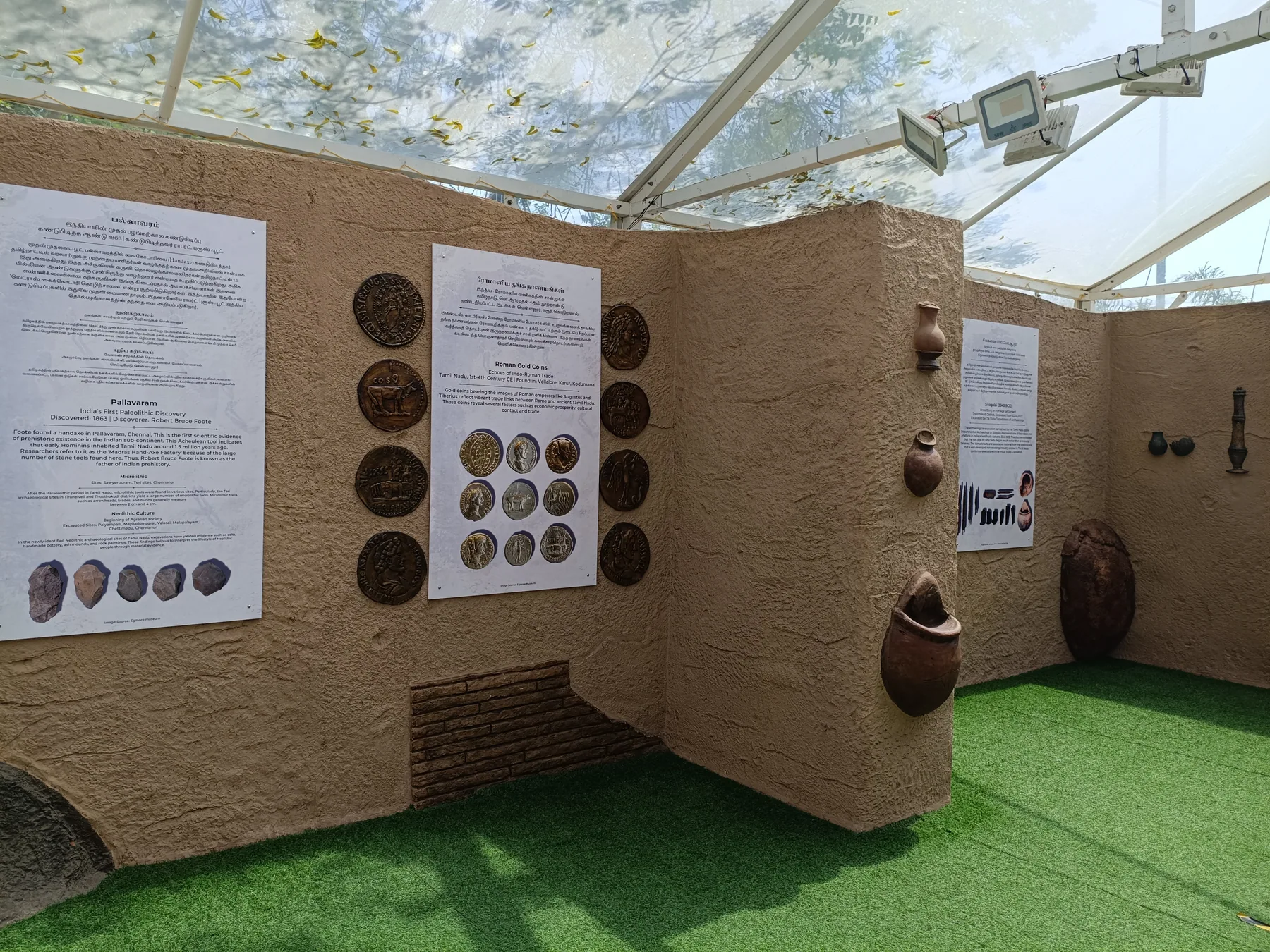 Pavilion walls with illustrated panels and artefact displays
