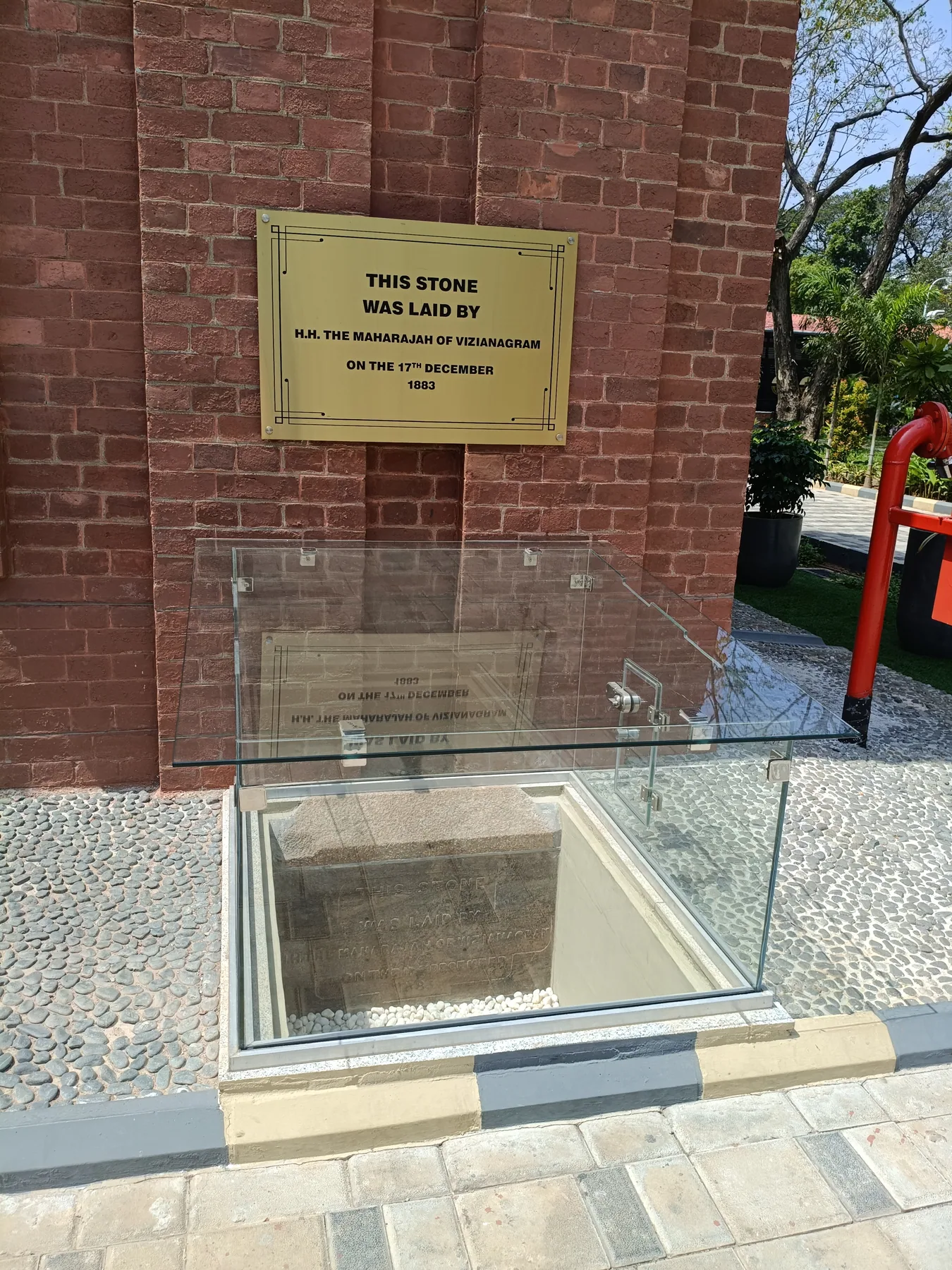 Glass-covered plaque beside the museum entrance