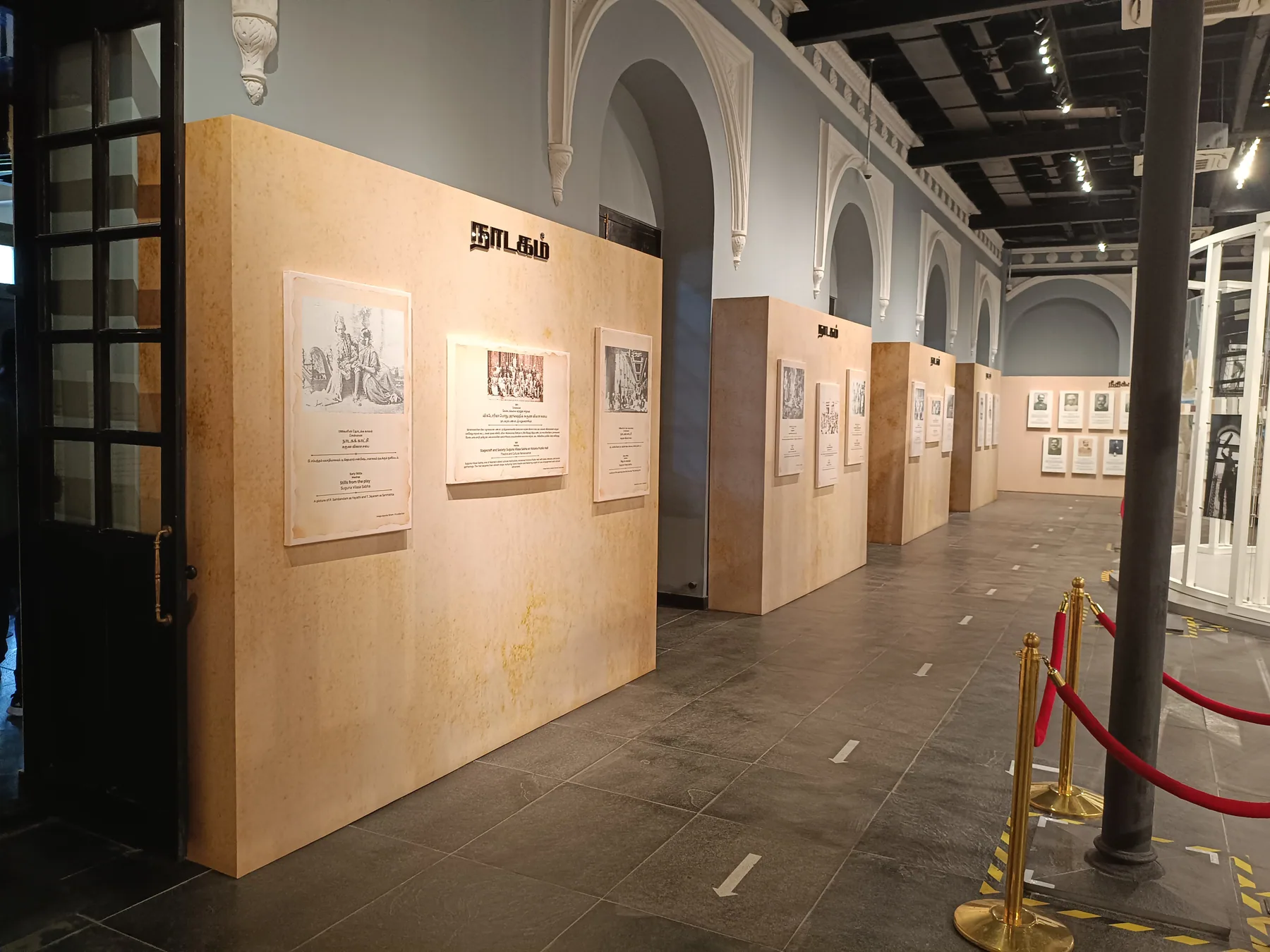 Interpretation wall and circular display beneath gallery lighting