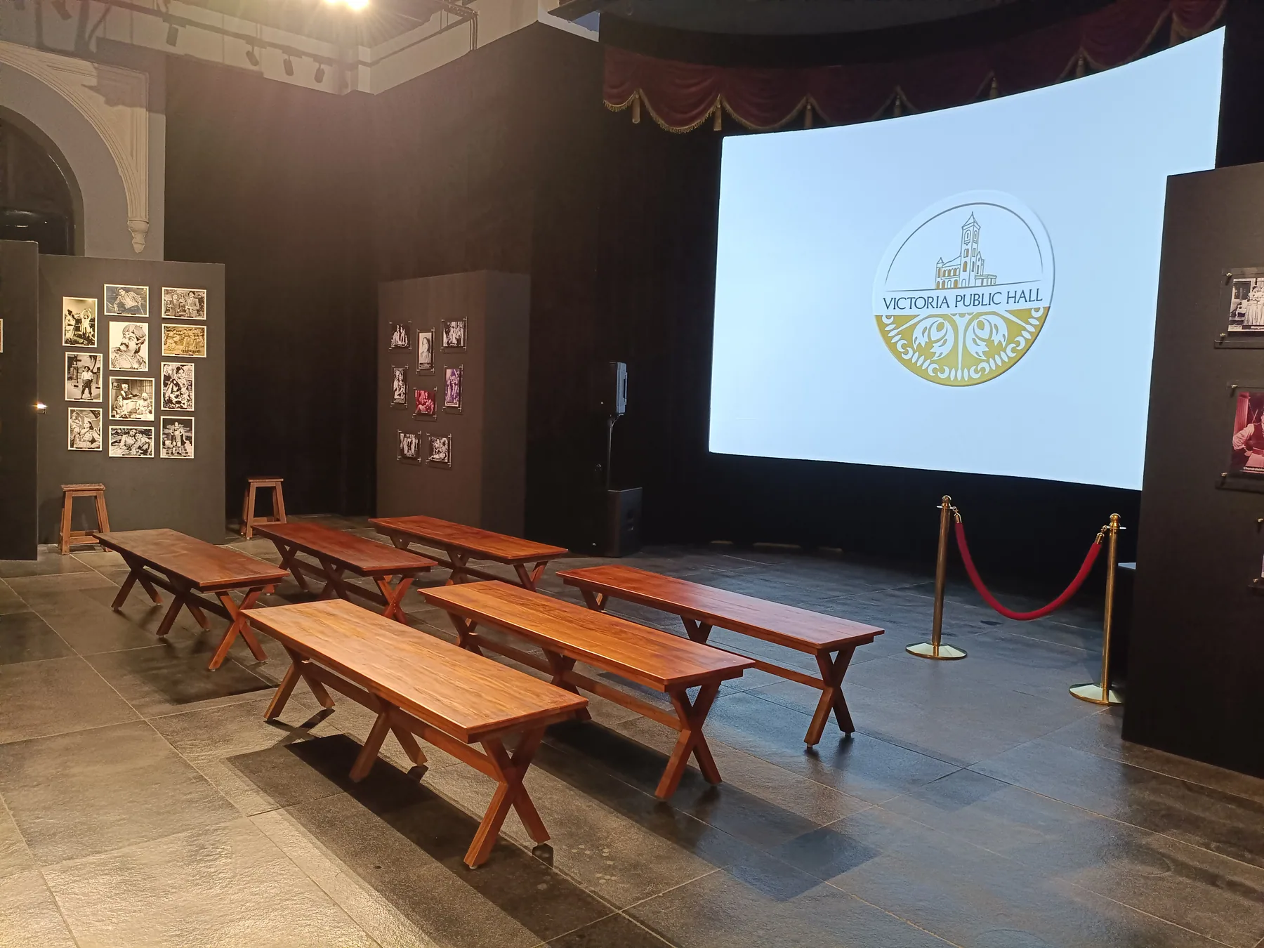 Projection screen and rows of timber benches