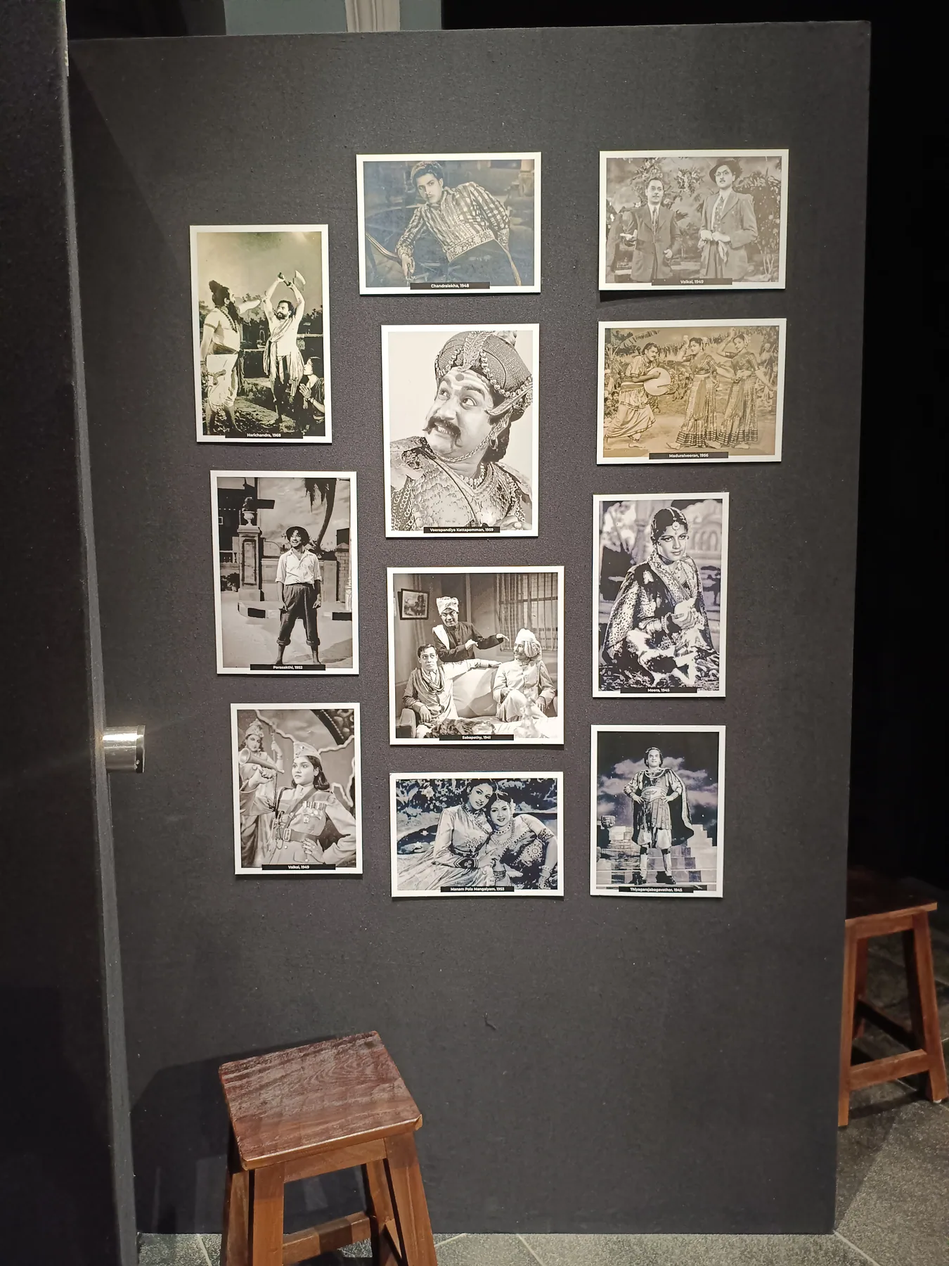 Historic photographs mounted on a dark exhibition wall