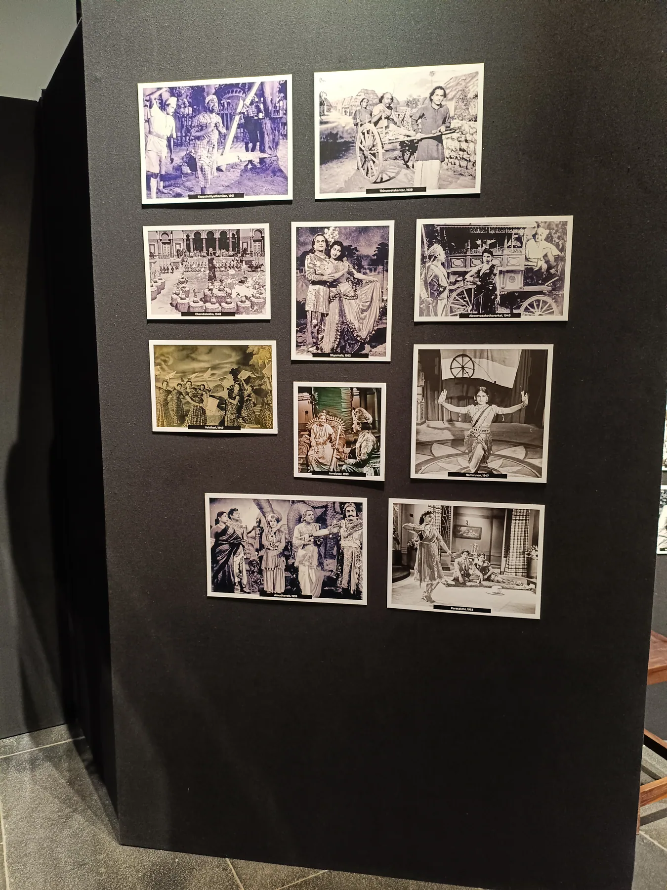 Close view of historic photographs on a dark wall