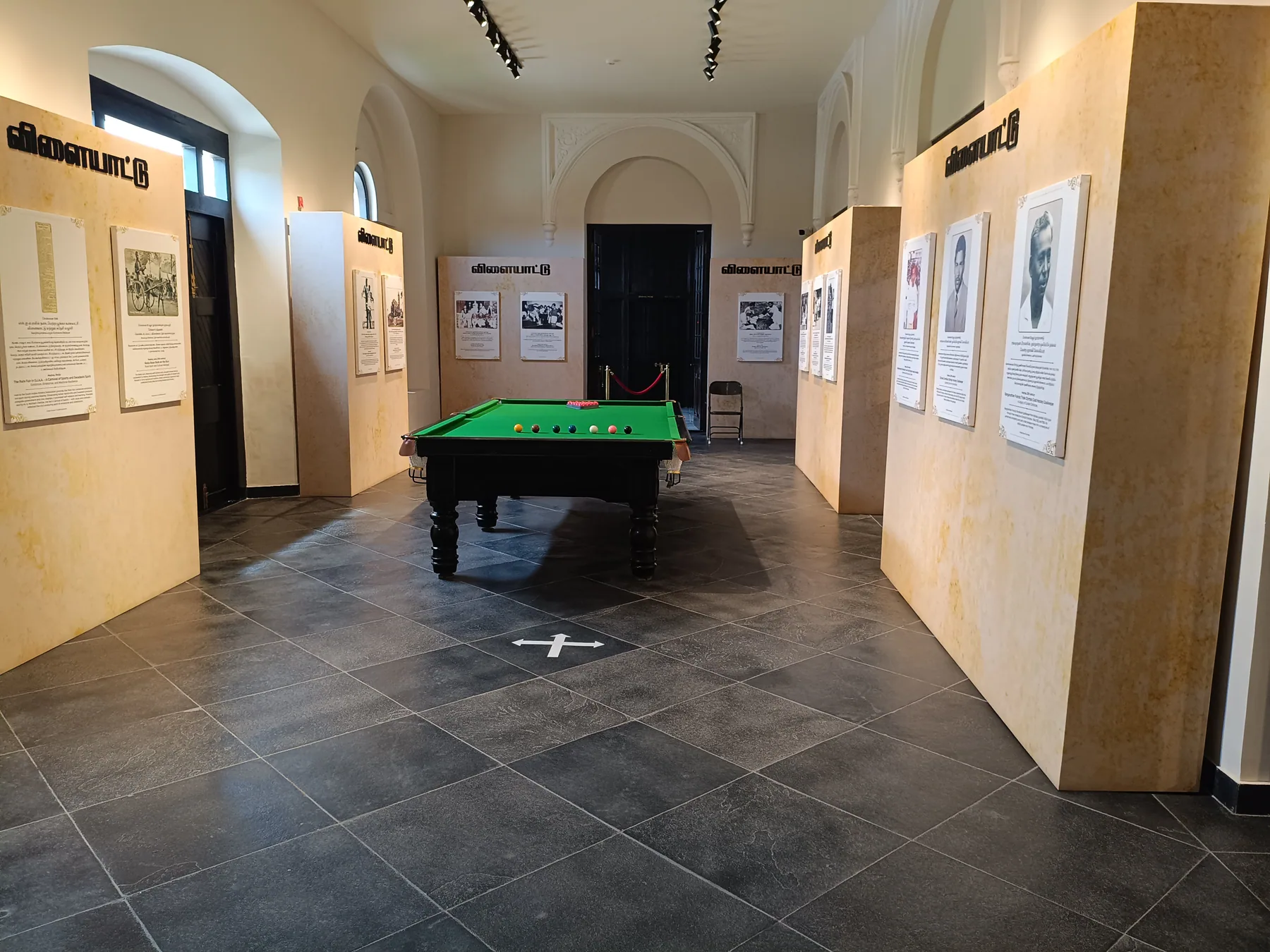 Billiard table within a gallery of interpretation panels