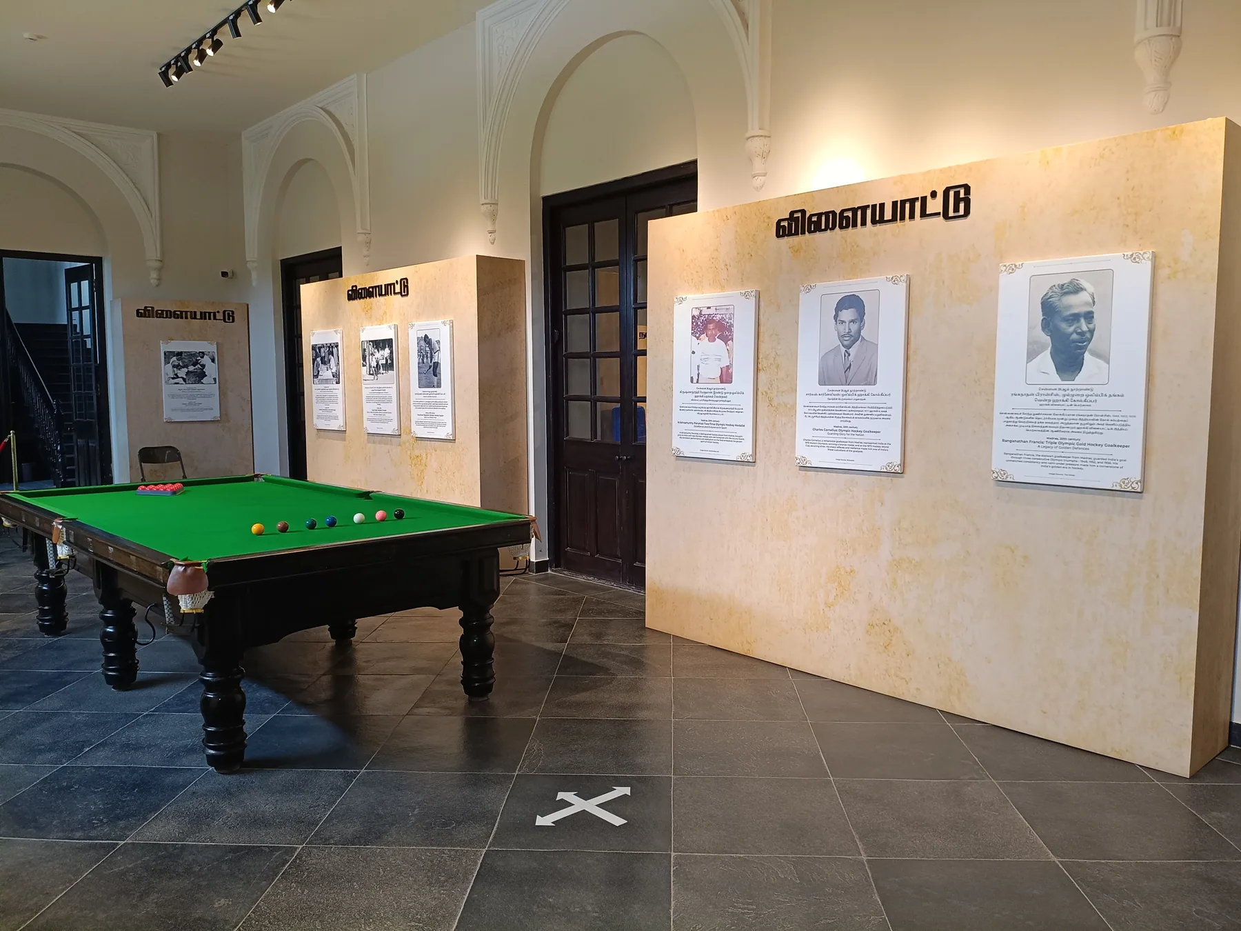 Billiard exhibit beside freestanding interpretation walls