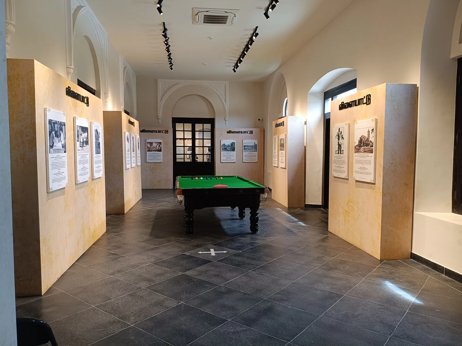 View down the gallery toward the billiard exhibit