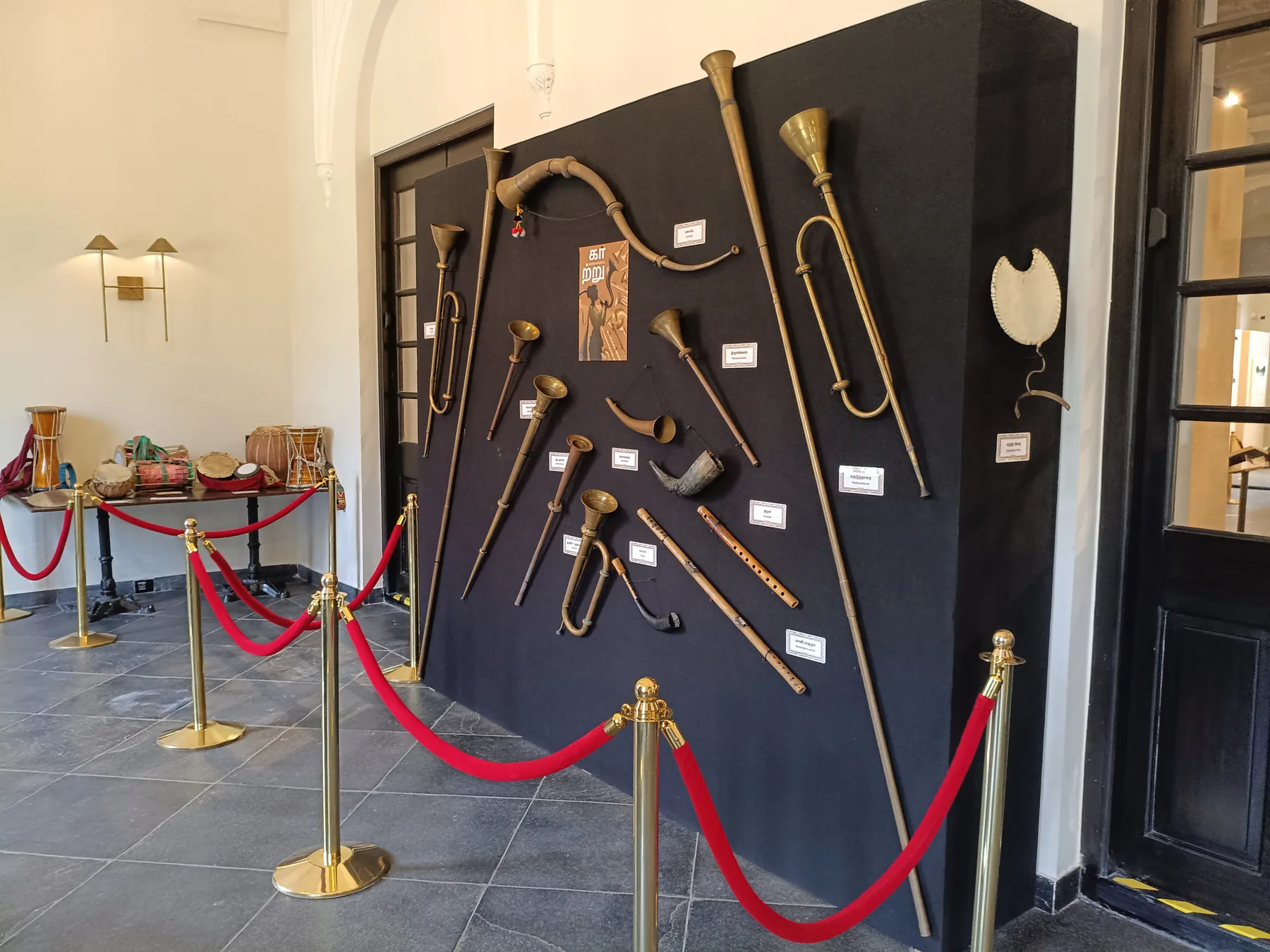 Curved objects arranged on a dark exhibit panel