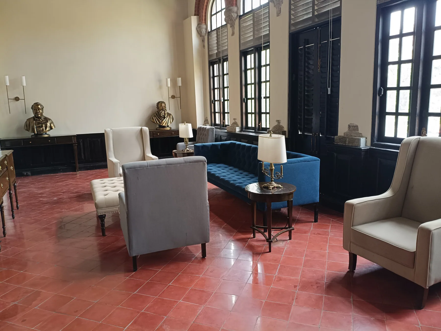 Visitor seating beside tall gallery windows