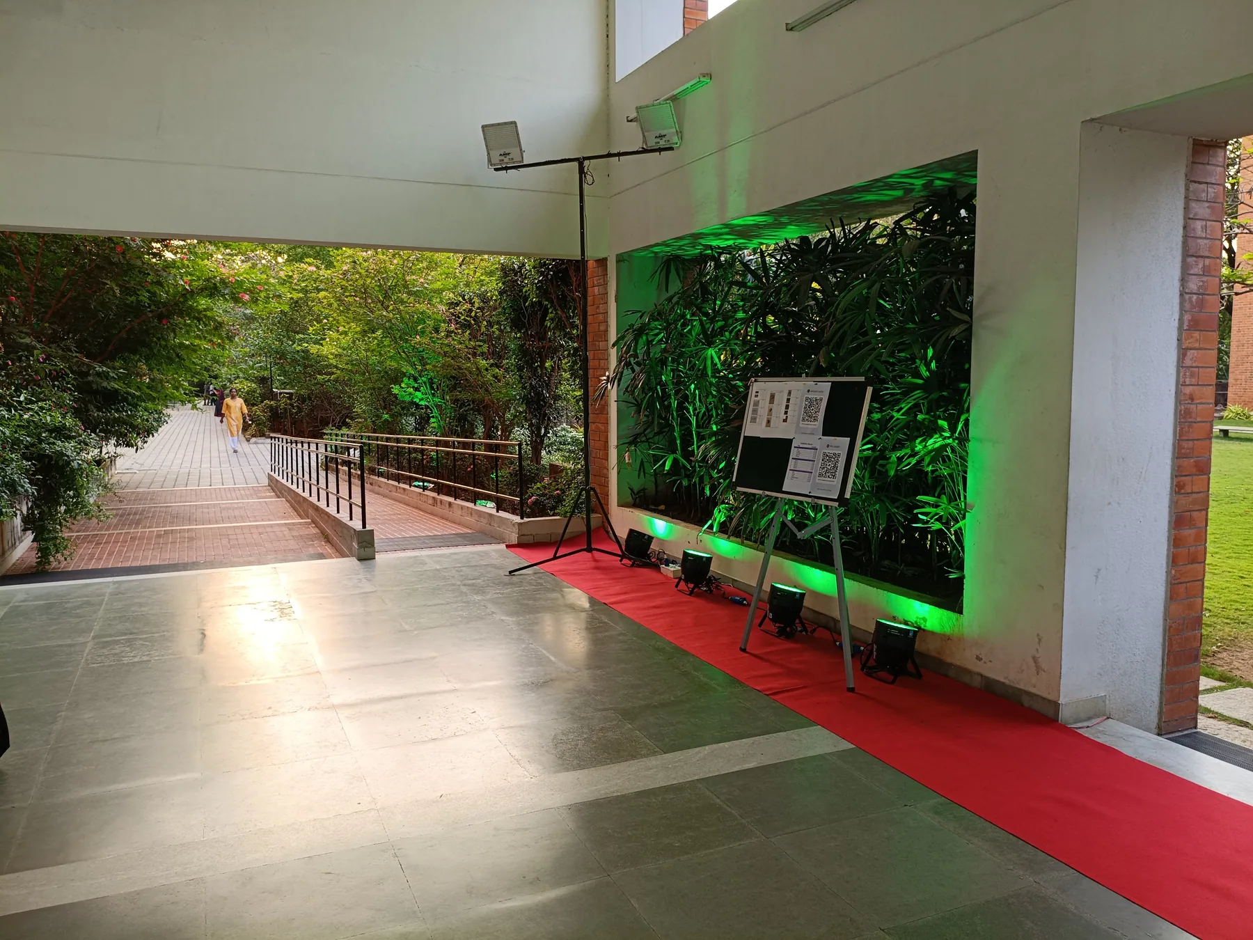 Gallery approach with a planted wall and red carpet