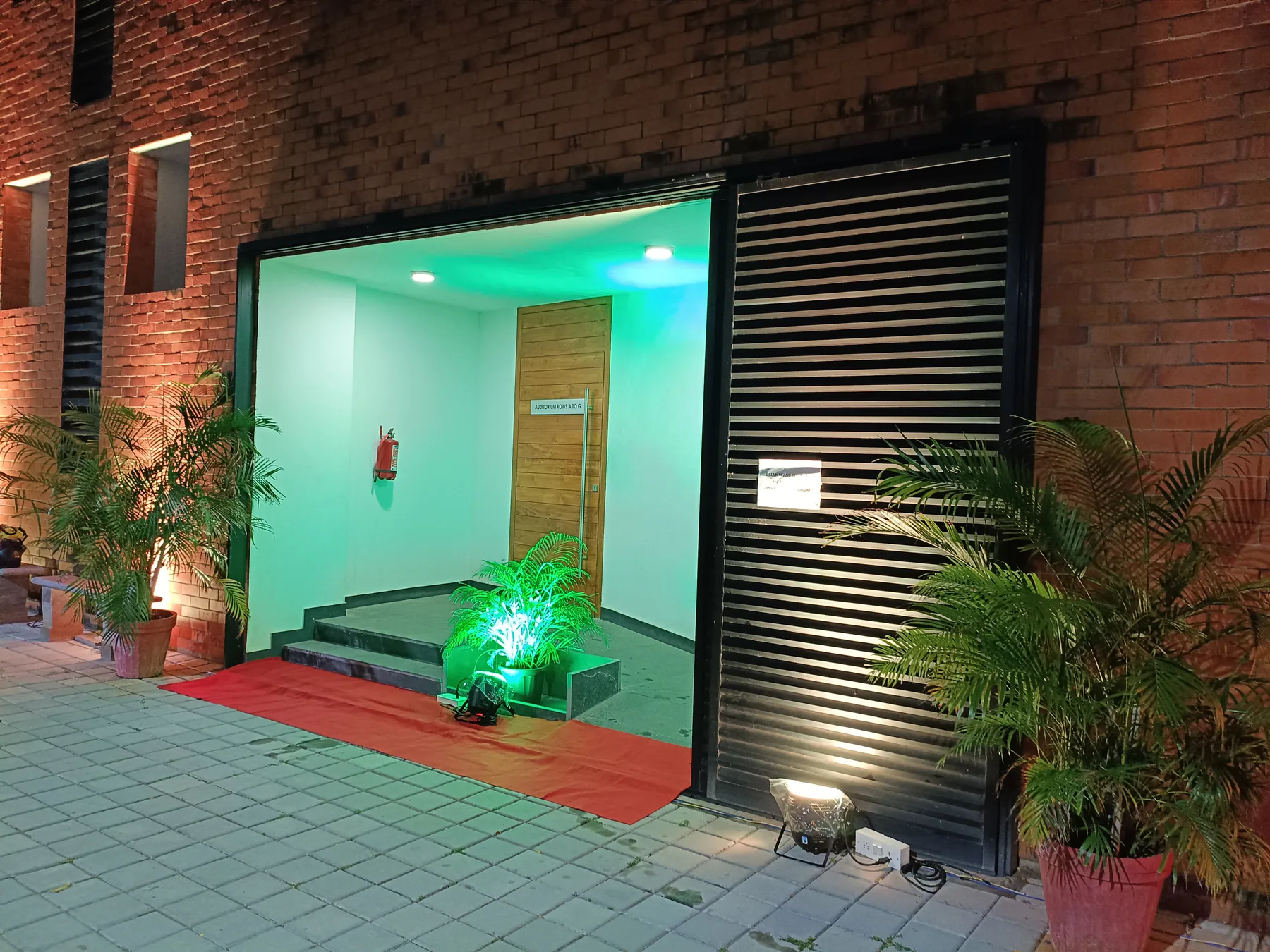 Green-lit exterior doorway
