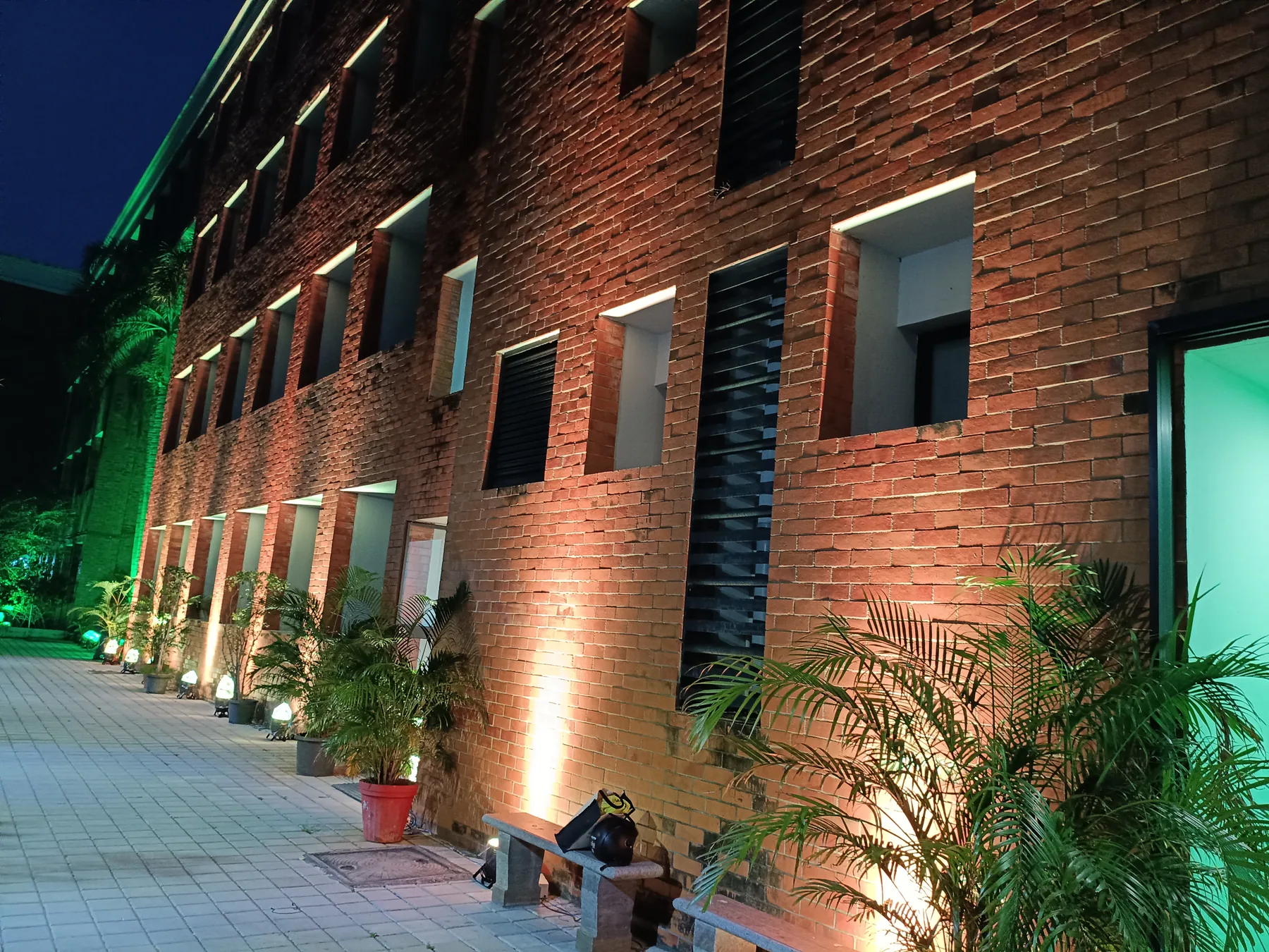 Uplit facade with green light at the entrance