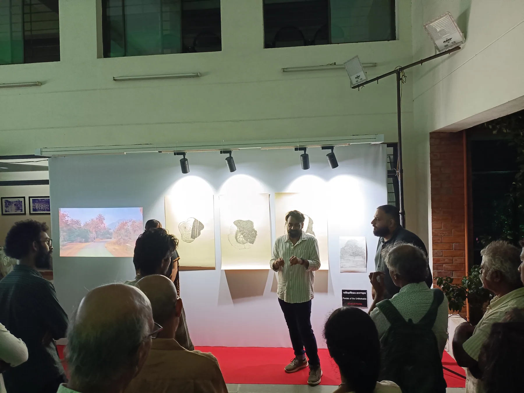 Visitors gathered beside the displayed artwork