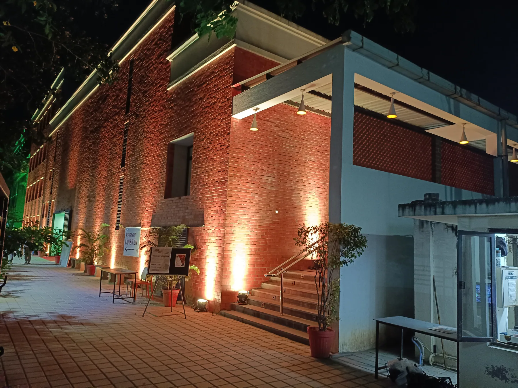 Wide evening view of the illuminated brick building